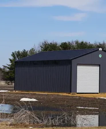 Large metal black storage unit sits on roadside.